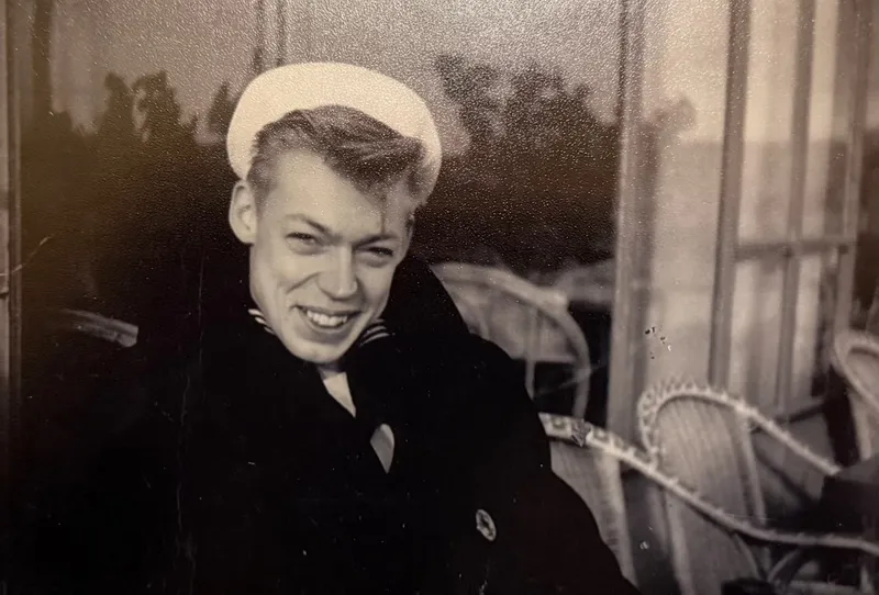 Clifford Johnson as a young sailor in his Navy cap and peacoat, smiling