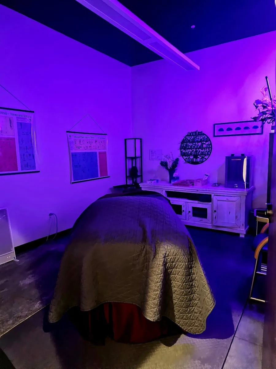 The massage treatment room in soft purple light